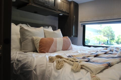 Master bedroom includes an RV King bed w a LED 32” Television, complete set of linens, plenty of storage, and access to the dual entry bath. 
