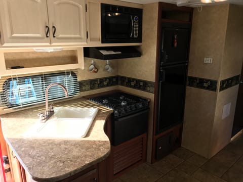 Large indoor kitchen with microwave.