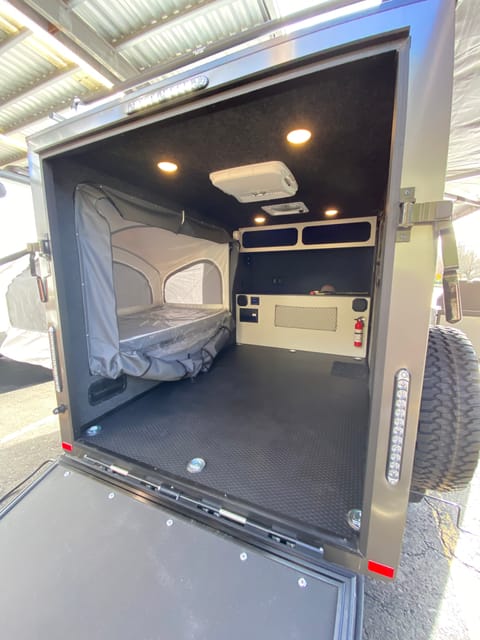 Hang out in the back with all the amazing views! While watching a movie on the projector screen…. Or tailgate party with a safe place to crash!!