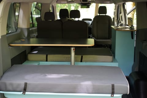 We designed the eating area inside the van to maximize space and easily convert to a bed when you're ready to sleep.