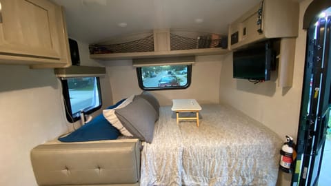 View Of The Bed Space From The Bathroom, TV Comes On A Swivel Mount, Games & DVD’s In The Space Above The Bed, Mini Box Fan, Tons Of Pillows!