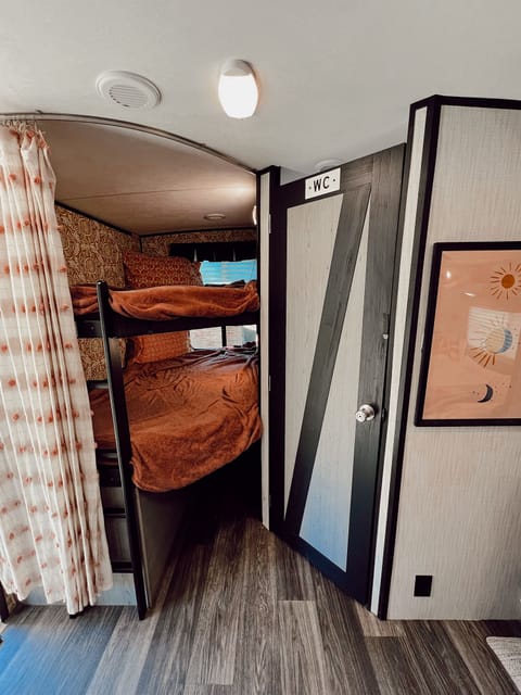 Twin XL bunks with custom interior walls. Features an accessible ladder & privacy curtain. Underneath storage is great for luggage bags or dog beds.