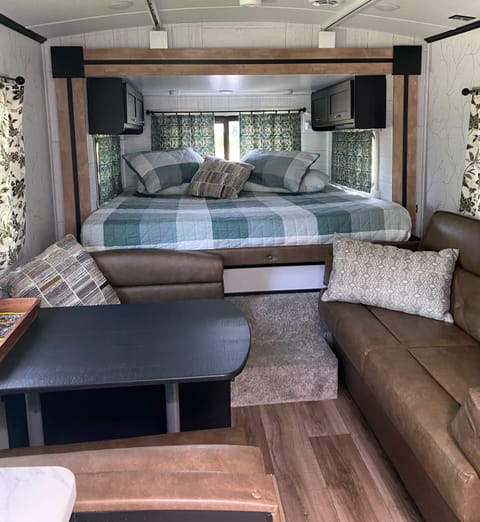 King Bed with a 2 inch gel/memory foam mattress,  3 windows to let in the cool night air, extra blankets in the cabinets, 2 phone holders near head, 3 individual overhead lights for reading.