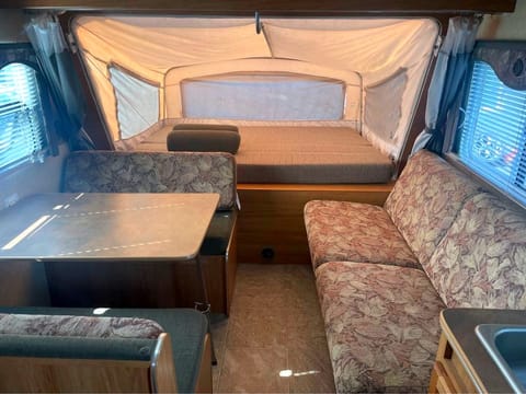 Queen sized bed on the fold out platform with zippered windows all around. Both the dinette table and couch make a double bed each.