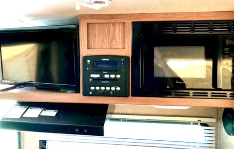 Kitchen includes a refrigerator, freezer, sink, microwave and propane stovetop. 