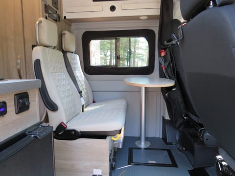 Two jumpseats with seatbelts behind the driver with removable table.