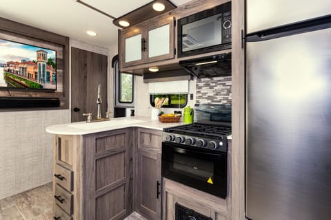 Beautiful kitchen with L-shaped counter and designer backsplash