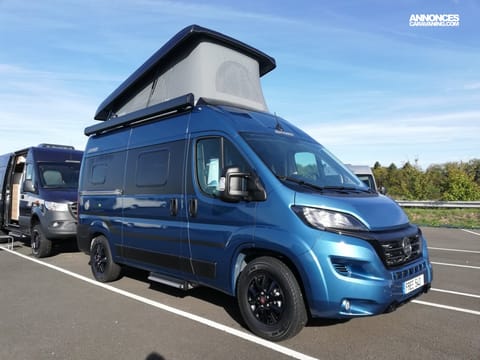 Hymer with Image of the pop top up 