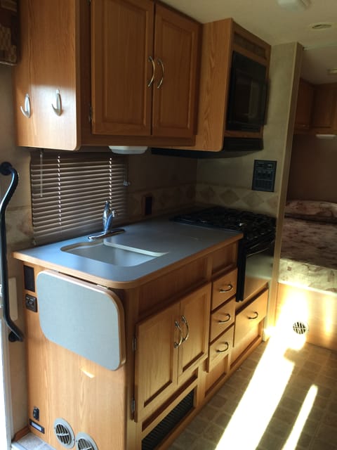 Nice compact kitchen fully loaded with Microwave, stovetop, and all the dishware and silverware you will need.  Easy to clean and ready to use. 