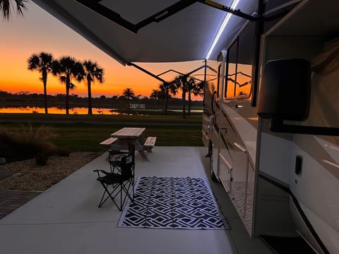 Awning and patio lights create a nice atmosphere on ythe patio