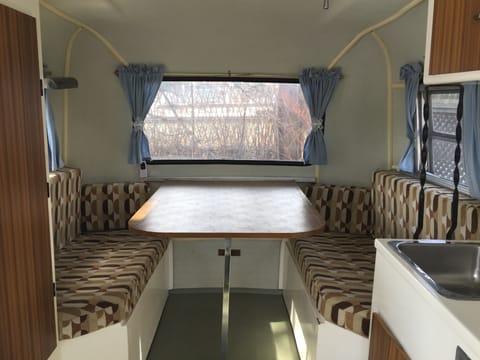 Comfy dining area with great viewing louvered windows. Table drops for a double bed.