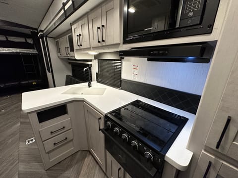 Kitchen sink, microwave, stove and oven