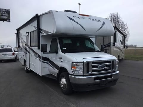 The RV fits in one parking space wide, two deep. But you will want two wide for entering and exiting the coach comfortably and putting the slides out.