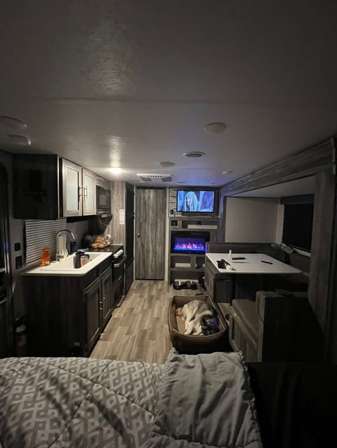Living area, U-shaped dinette, one queen bed and kitchen setup. 
