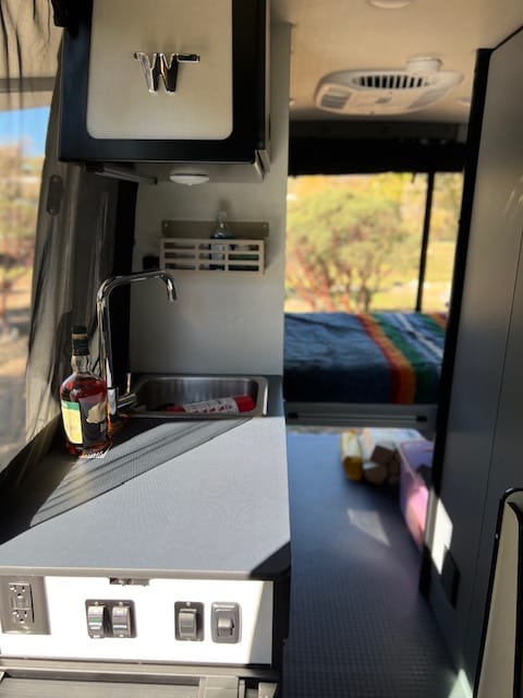 From the front of the van you can look back and see your kitchen area and bed. Open the back doors and relax for an afternoon nap.
