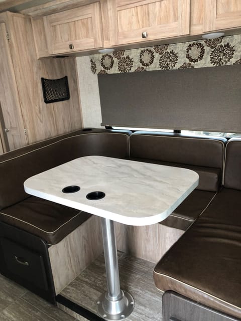 Dining table seats four and has four seatbelts. Easily converts to another queen bed. Bedding provided. There’s a 4-USB charging outlet right above. 