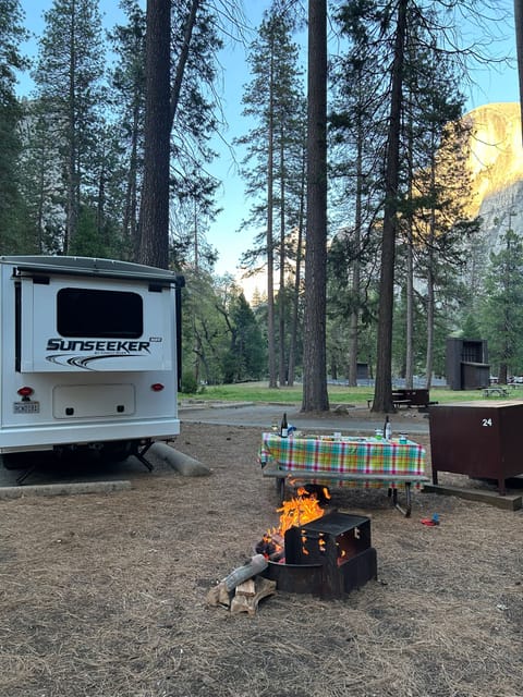 Lower Pines campground at Yosemite National Park with a spectacular view of Half Dome illuminated at sunset. 