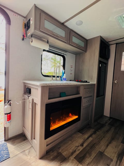 View of the kitchen and the fireplace. Gives it a cozy feel and the heater will definitely keep you warm. 