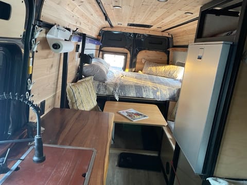 Wide angle shot of the interior.  The table swivels and tucks under.  Custom Sunbrella cushions. Window opens behind one seat.  It's all cedar and smells like a little cabin.