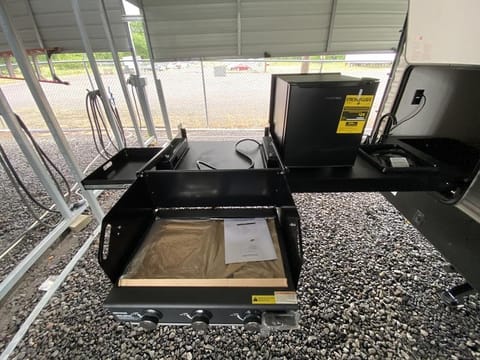 BBQ grill, mini fridge and hand washing sink.