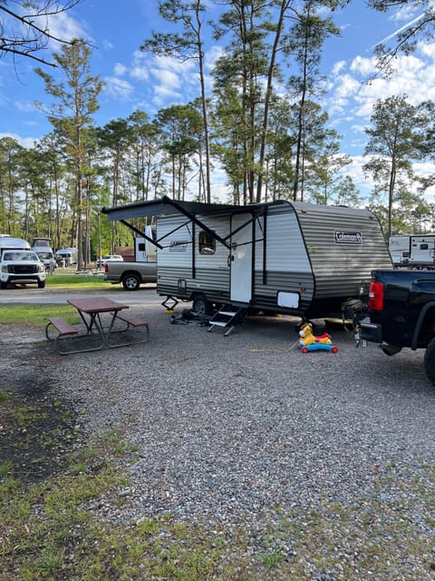 The front of the camper with awning and steps set out