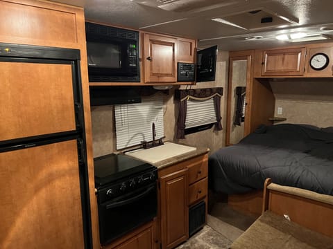 There is a fridge, microwave, sink, and stove in the camper. We will also include a 17 inch black stone for cooking outside. 