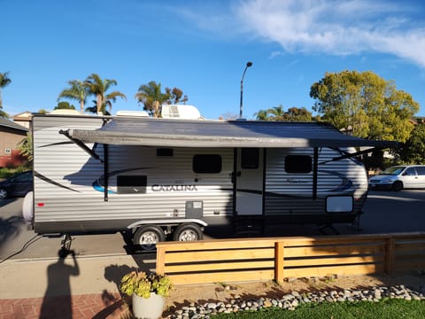 Lights line the outside of the trailer and escape the sun under the awning.