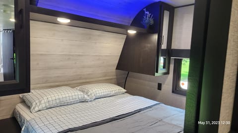 Master bedroom with queens size bed. 2 sliding doors for entry on each side, 2 openable windows, 2 closets, under bed storage area and mood lighting.