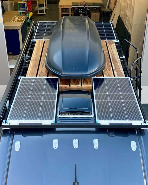 Optional Yakima rooftop cargo box, or a rooftop deck set between the four solar panels