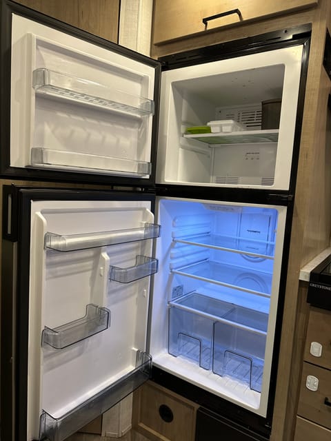 Large fridge and freezer with 2 ice cube trays.