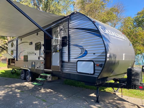 Front of travel trailer with an Automatic canopy  that extends out, 