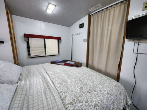 The bedroom has an amazingly comfortable queen bed. Side closets, towel hooks, and overhead & over bed storage. There is also a  TV & DVD player.