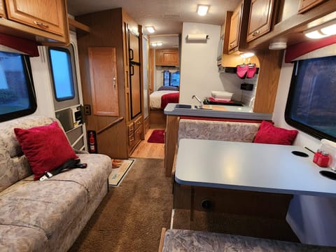 The main cabin features a jack knife sofa sleeper and dinette that folds easily into a bed. There is ample overhead storage over the sofa and dinette.