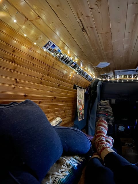 View of interior of van, from the perspective of laying on the bed. 