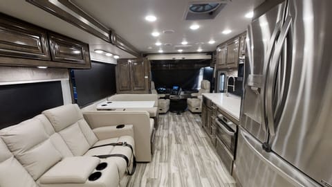 This Pet-friendly Class A RV has theater seats that are designed to provide you with a comforting embrace during your journey. They come with adjustable power settings to ensure you can find your perfect comfort level. 

And for those colder days, the seats even have a built-in heater to keep you warm and snug. Need a little relaxation? Activate the massage feature and let your stress melt away. 

We've also included accent lighting to create a soothing environment. The seats come with adjustable headrests and integrated USB and 110 outlets right in the armrest, so you can stay connected with your loved ones even while on the move. Your comfort and convenience is our priority.