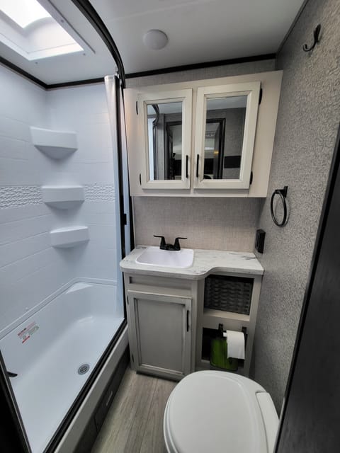 Full bathroom with upgraded shower head and spacious toilet