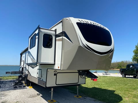 Unleash the epic 43' Wildwood Elite camper! Rev it up with an optional tow vehicle,  a massive 20' awning, and behold the grand front picture window. 