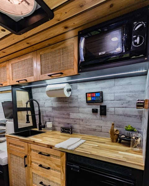 The kitchen is packed with everything you need to cook your favorite meals on the road! Coming with a sink, microwave, portable cooktop, and fridge/freezer you can stalk up on your favorite items and have a whole soiree!