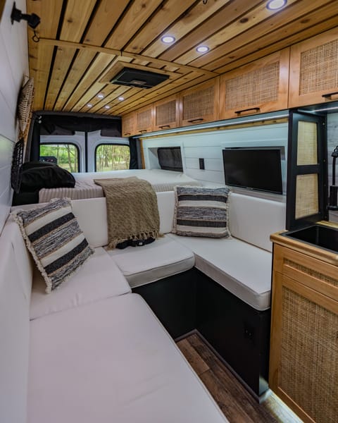 The living space of the vehicle has an open floor plan allowing easy maneuvering around the van. The wrap around couch also converts to a full size bed for the third traveler!