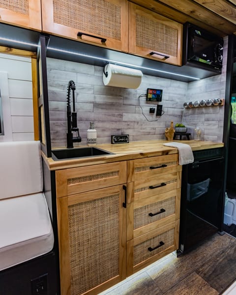 The kitchen comes stocked with all of your necessities such as plates, cups, bowls, utensils, cutlery, etc. You can power the lights, water, and view your battery using the touch screen tablet on the wall!