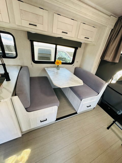 Dinette that converts to a bed to sleep 1-2. 
Extra long cabinets below and lots of storage above. 
Two seat belts and one for a child seat
