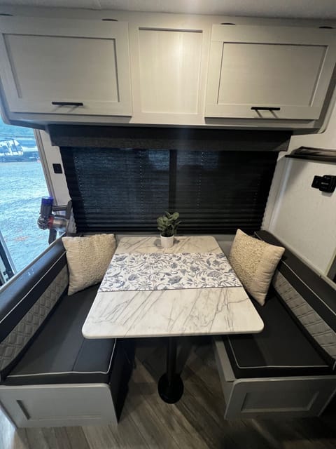 Plenty of storage under the seats in this dinette! Table pulls out to create a small bed.