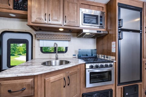 Kitchen with stainless appliances. The fridge and freezer have impressive storage.  We love preparing our own meals when we travel.  