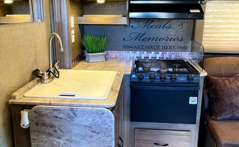 Kitchen area with large sink and extra pop up counter space makes it easy to prepare meals. 