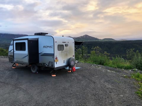 This baby is perfect for boondocking! You may CAMP on gravel pullouts or parking lots, but may not drive more than a mile on unpaved surfaces.