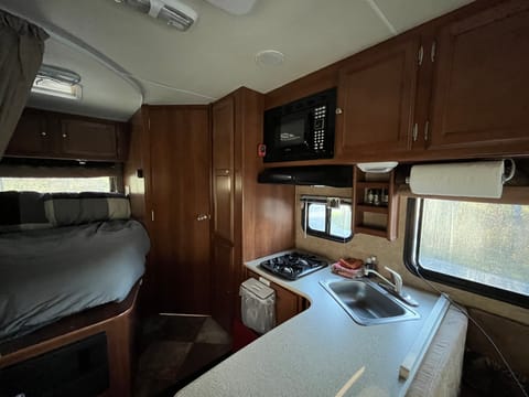 Great size counter for meal prep, 2 burner stove, microwave and so much space in this compact RV.