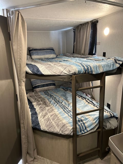 Full size bunks with USB charging ports, separate windows, separate reading lights, and a privacy curtain. 