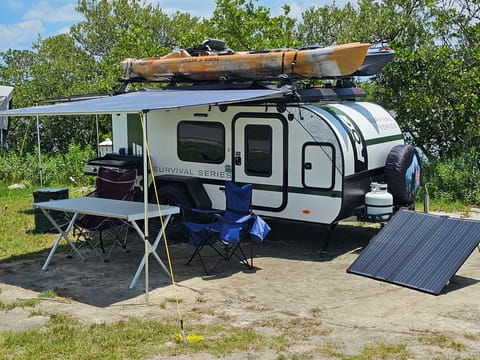 Exterior with dining table, 2 chairs, garbage bin, plus Optional Blackstone Griddle and Optional 200w Solar Panel.
KAYAKS NOT INCLUDED