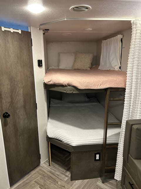 Double size bunks. There is a space under the bottom for storage and an electrical outlet to connect a computer when sitting at the u-dinette.