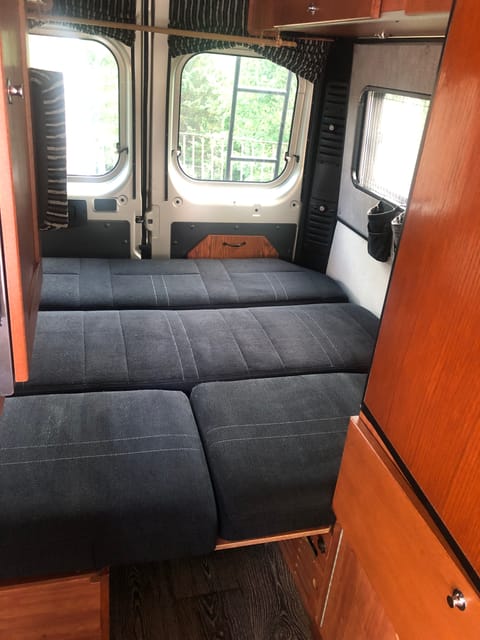 This shows the seat folded down to form the bad. It is designed for people to sleep crossways, with head and feet to the sides of the RV.